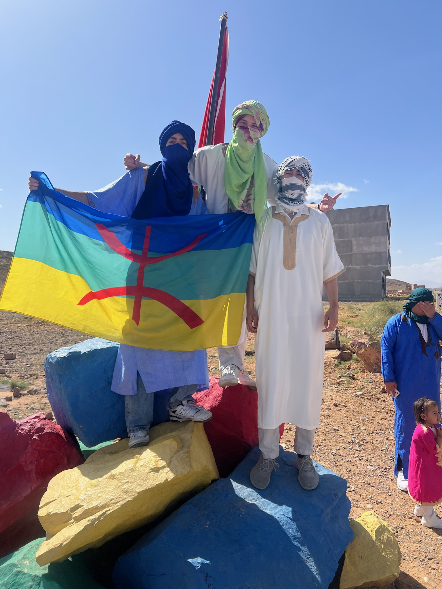 Andre and friends holding a flag in Morocco